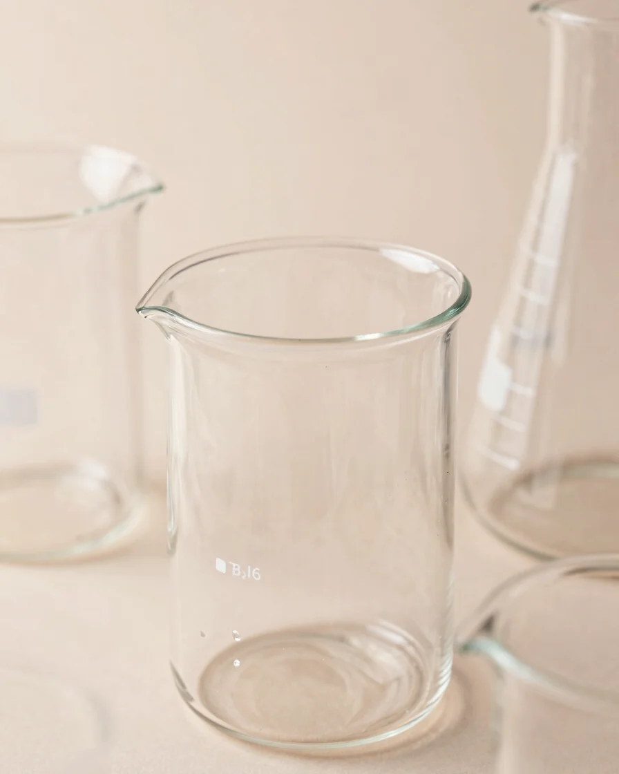 Clean lab glassware displaying delicate textures, soft diffused studio light, crisp detail